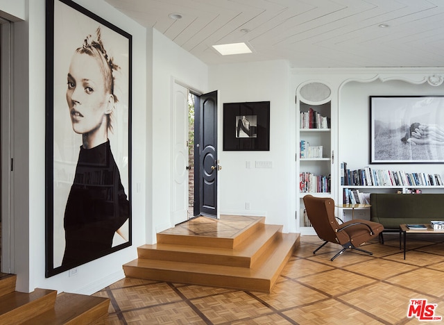 entrance foyer featuring parquet flooring