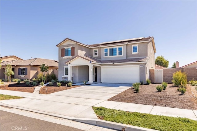 view of front of home featuring solar panels and a garage