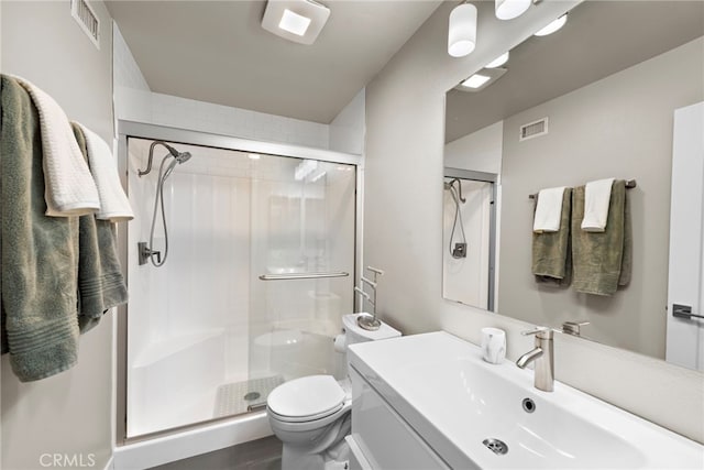 bathroom with toilet, walk in shower, and vanity