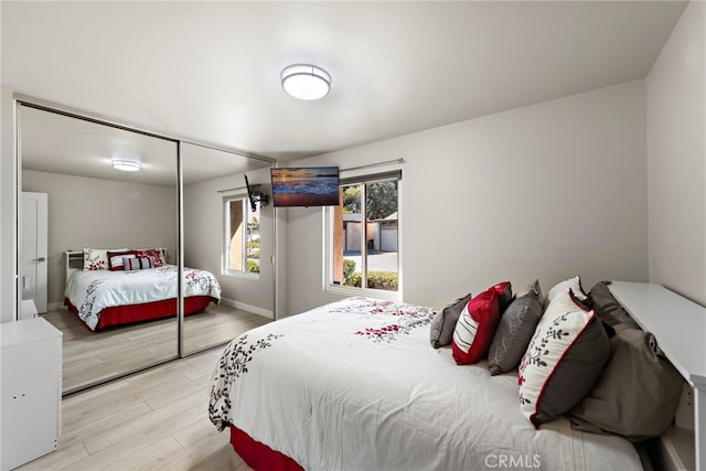 bedroom with a closet and light hardwood / wood-style floors