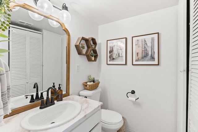 bathroom with toilet and vanity