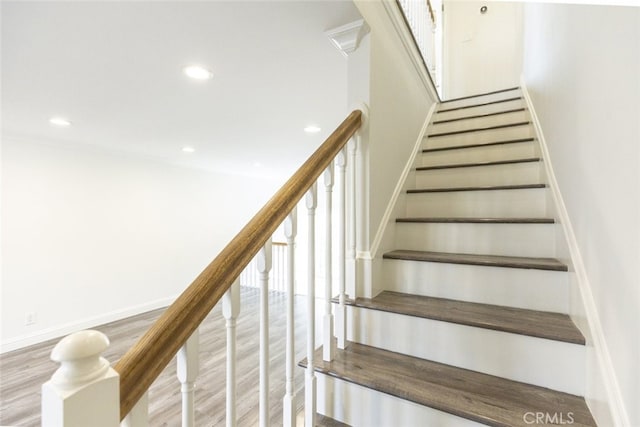 stairway featuring wood-type flooring