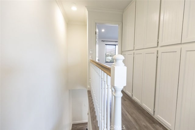 stairs featuring ornamental molding and wood-type flooring