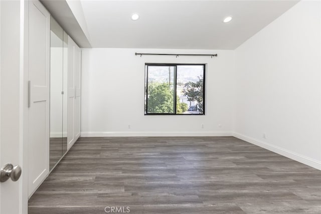 unfurnished bedroom featuring dark hardwood / wood-style flooring