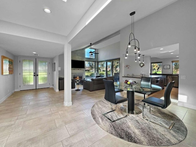 dining room featuring ceiling fan, french doors, and high vaulted ceiling