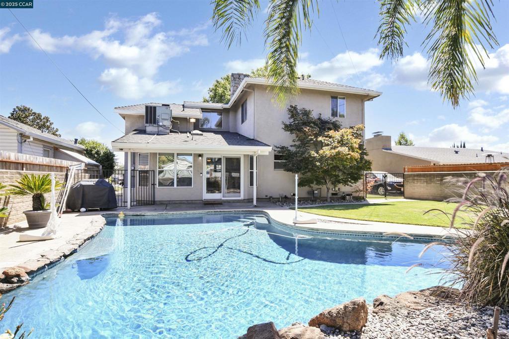 view of pool featuring grilling area and a yard