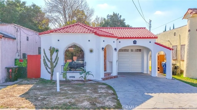 mediterranean / spanish house with a garage