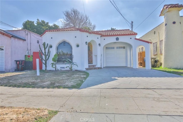 mediterranean / spanish home featuring a garage