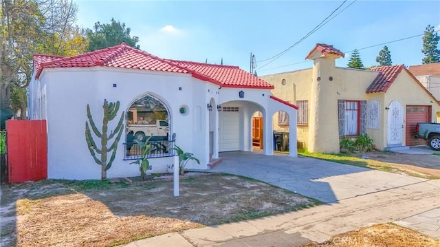 mediterranean / spanish house with a garage