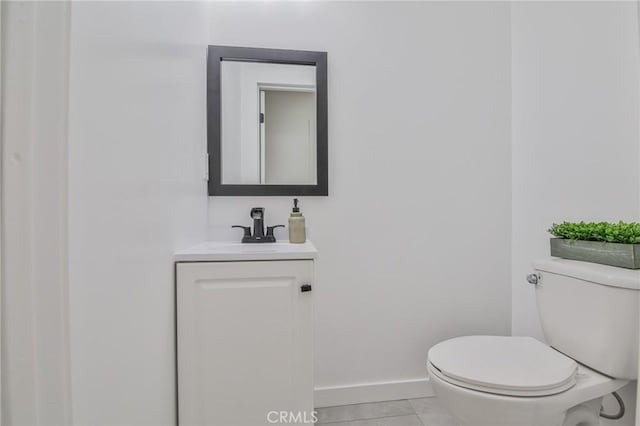 bathroom featuring toilet, tile patterned flooring, and vanity