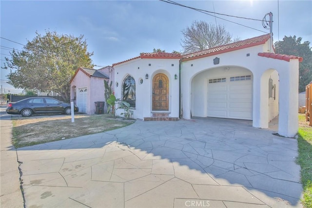 mediterranean / spanish home with a garage