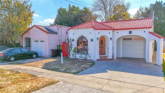 mediterranean / spanish house with a garage