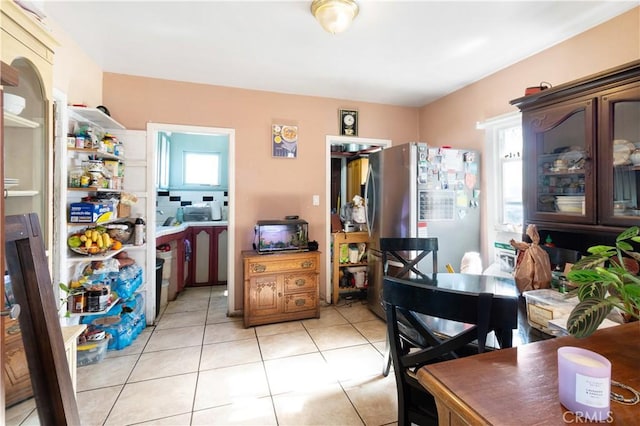 dining room with a wealth of natural light and light tile patterned flooring