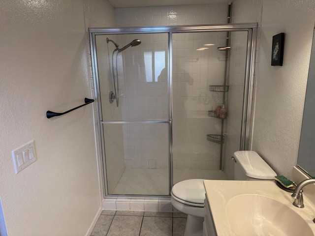 bathroom featuring toilet, an enclosed shower, tile patterned flooring, and vanity