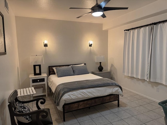 tiled bedroom with ceiling fan