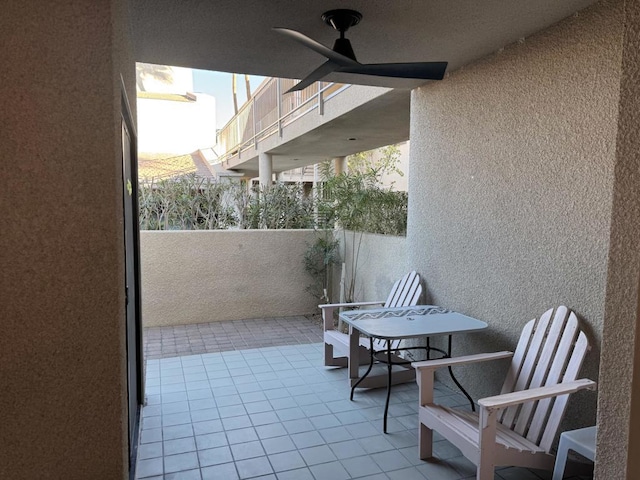 balcony with ceiling fan and a patio