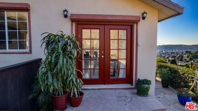 entrance to property featuring french doors and a patio area