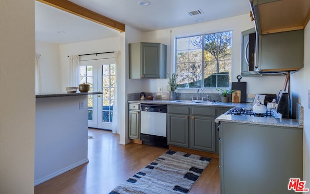 kitchen featuring stainless steel appliances, sink, french doors, gray cabinets, and dark wood-type flooring