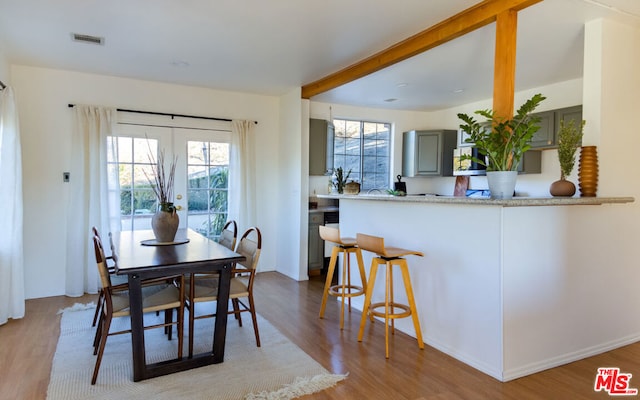 dining area featuring french doors and light hardwood / wood-style floors