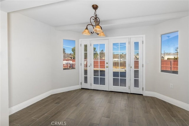 doorway featuring dark wood-type flooring, french doors, and an inviting chandelier