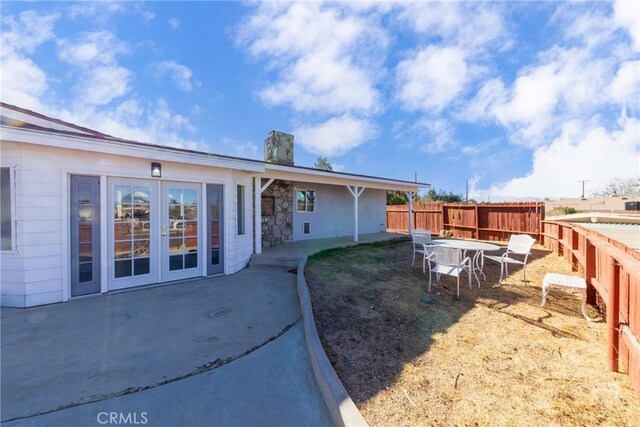 back of house featuring a patio area and french doors