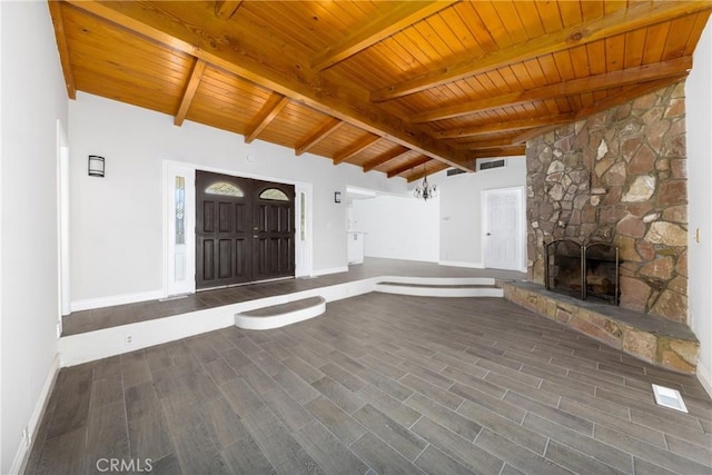 unfurnished living room featuring a fireplace, lofted ceiling with beams, and wood ceiling