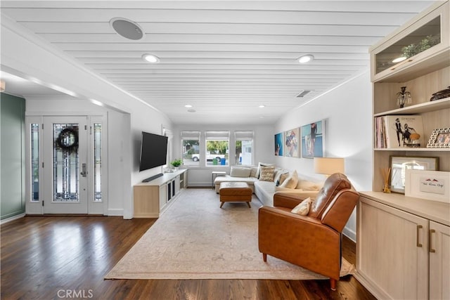 living room featuring dark wood-type flooring and wooden ceiling