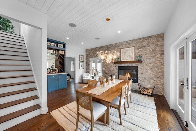 dining space featuring wood ceiling, dark wood-type flooring, french doors, and a fireplace