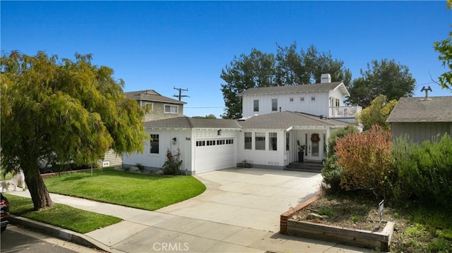 view of front of home with a front yard and a garage