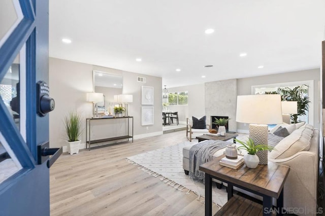 living room featuring a fireplace and light hardwood / wood-style flooring