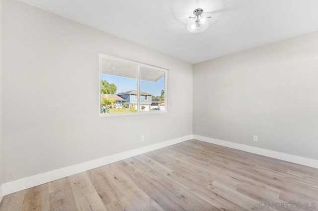 empty room with light hardwood / wood-style floors