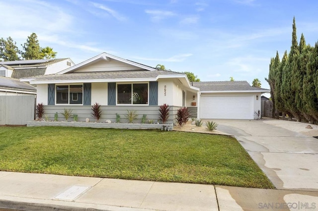 ranch-style house featuring a front yard and a garage