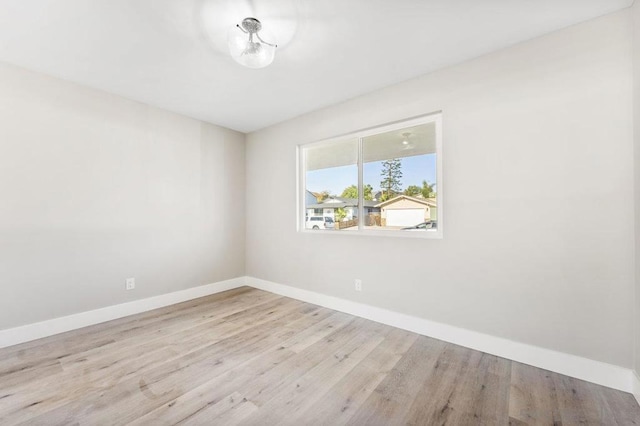 unfurnished room with light wood-type flooring