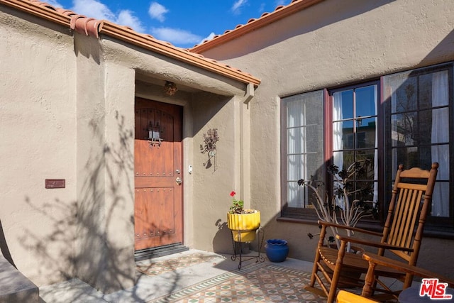 doorway to property with a patio