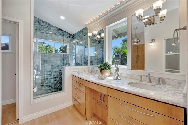 bathroom featuring vaulted ceiling, wood-type flooring, walk in shower, vanity, and a notable chandelier