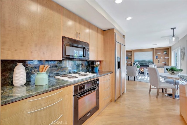 kitchen with light hardwood / wood-style flooring, black appliances, decorative backsplash, built in features, and dark stone countertops