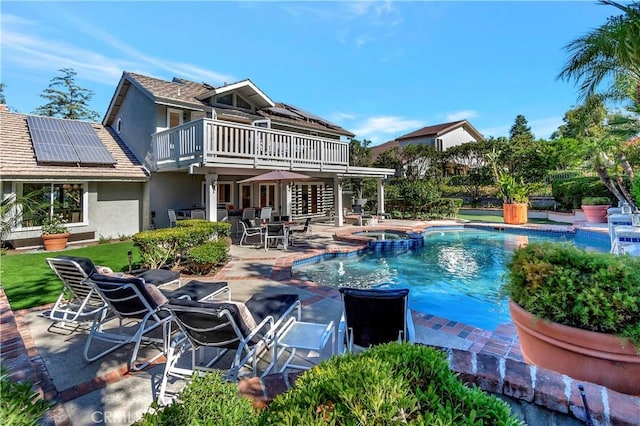 view of pool with a patio area and an in ground hot tub