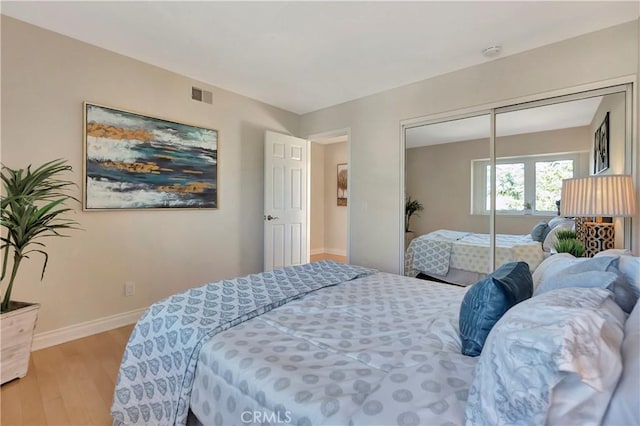 bedroom featuring a closet and light wood-type flooring