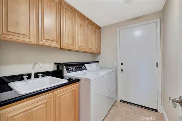 washroom with independent washer and dryer, cabinets, light tile patterned floors, and sink