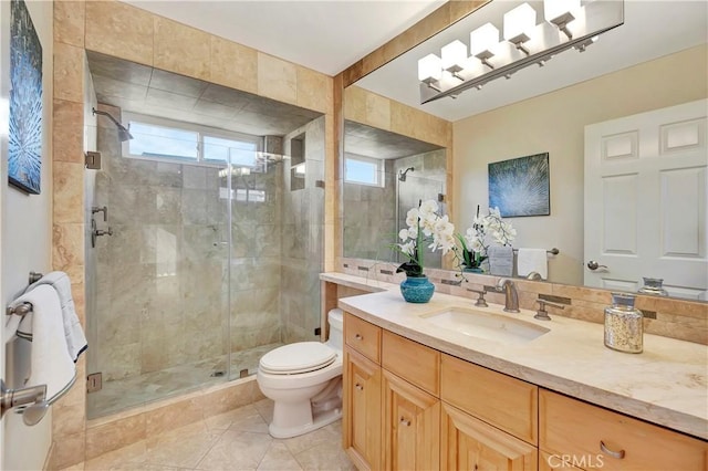 bathroom featuring toilet, vanity, tile patterned flooring, and walk in shower