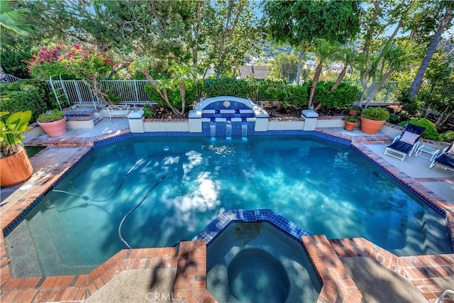 view of swimming pool featuring an in ground hot tub and a patio