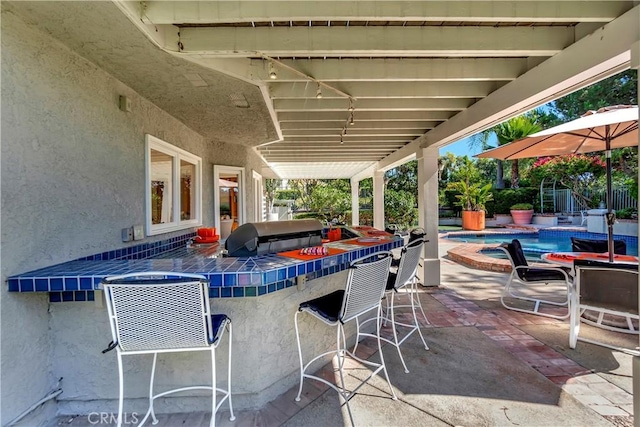 view of patio featuring a pool with hot tub and a bar