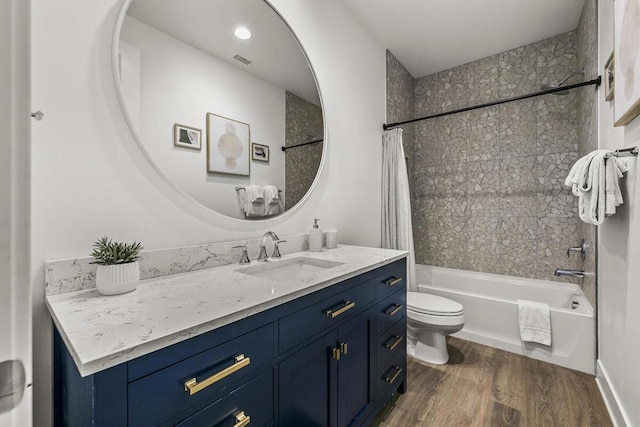 full bathroom featuring vanity, toilet, shower / bath combo with shower curtain, and hardwood / wood-style flooring