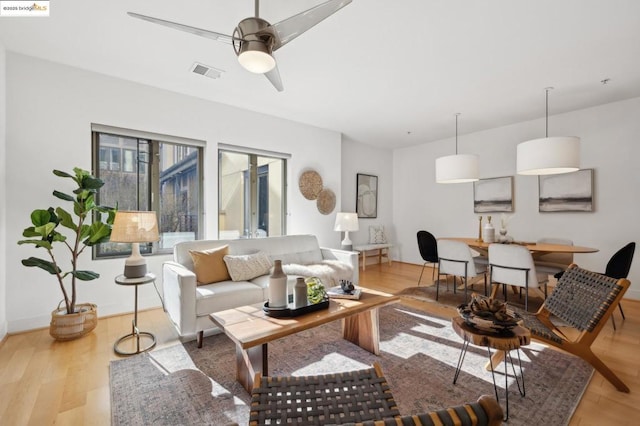 living room featuring ceiling fan and light wood-type flooring