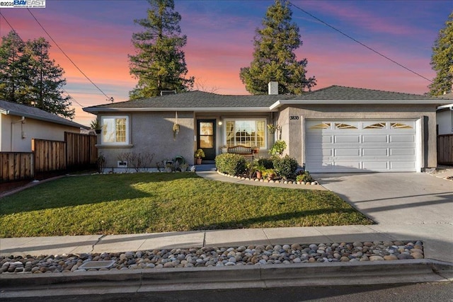 ranch-style house with a lawn and a garage