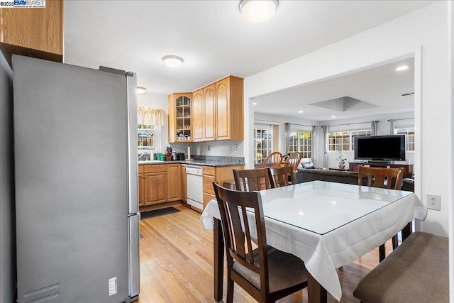 kitchen featuring light wood-type flooring, dishwasher, and stainless steel fridge