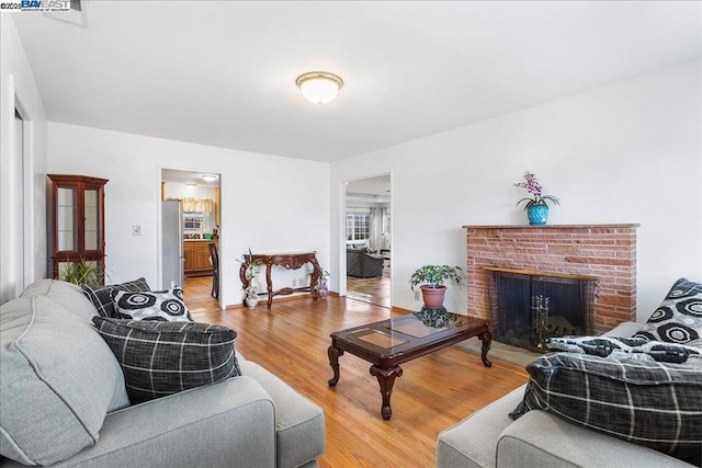 living room with a fireplace and hardwood / wood-style flooring