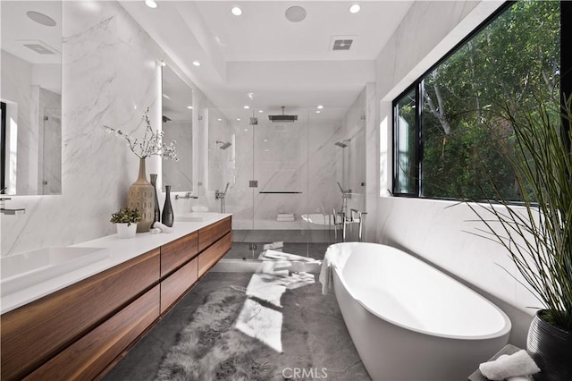 bathroom with vanity, shower with separate bathtub, and concrete flooring