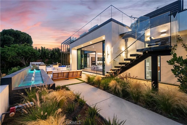 patio terrace at dusk featuring an outdoor living space