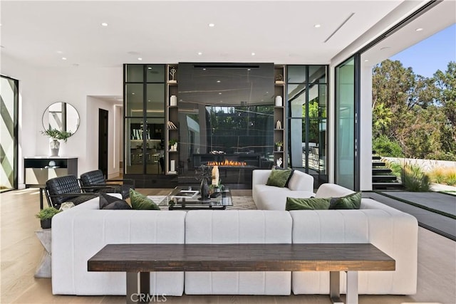 living room featuring expansive windows and light wood-type flooring